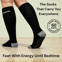 Black knee-high Bambelle StepMassage Arch Socks with grey heel and toe and the StepGrip Sole in mid-step on a wooden floor, with a 60-day money-back guarantee badge