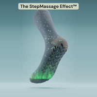 A Bambelle StepMassage Arch Sock turns in 3D while green light and sparkles rise from The StepGrip Sole up the calf, with callouts: The StepGrip Sole, chevron-shaped grips turn every step into a massage, massages your arch with every step, helps ease tired, achy legs, works inside every shoe