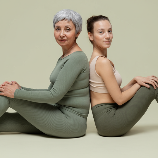 Two women back-to-back yoga pose