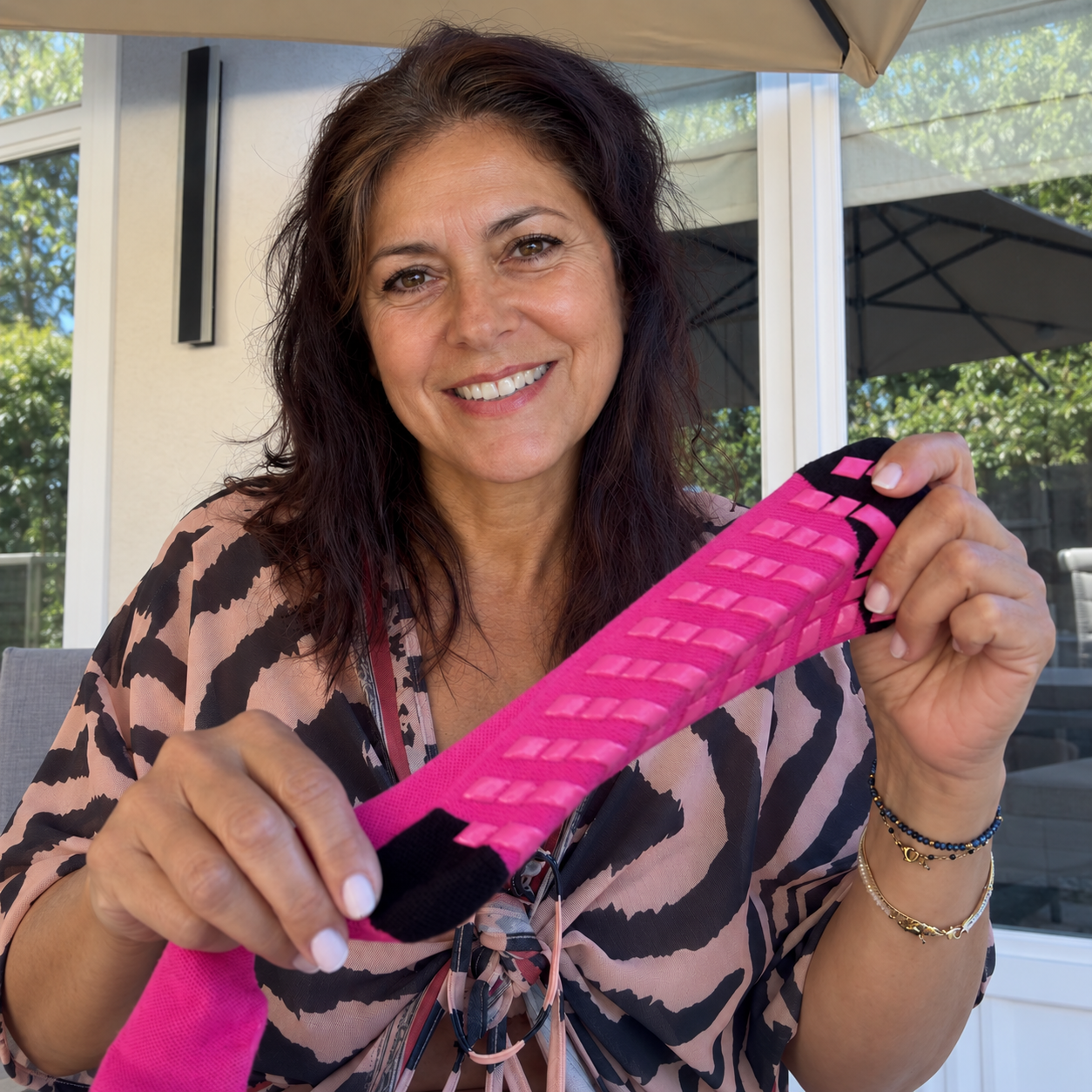 Bambelle customer photo, woman holding a dark pink Bambelle sock
